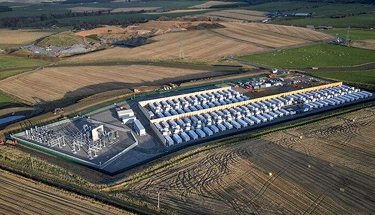 a large building with cars parked in a field